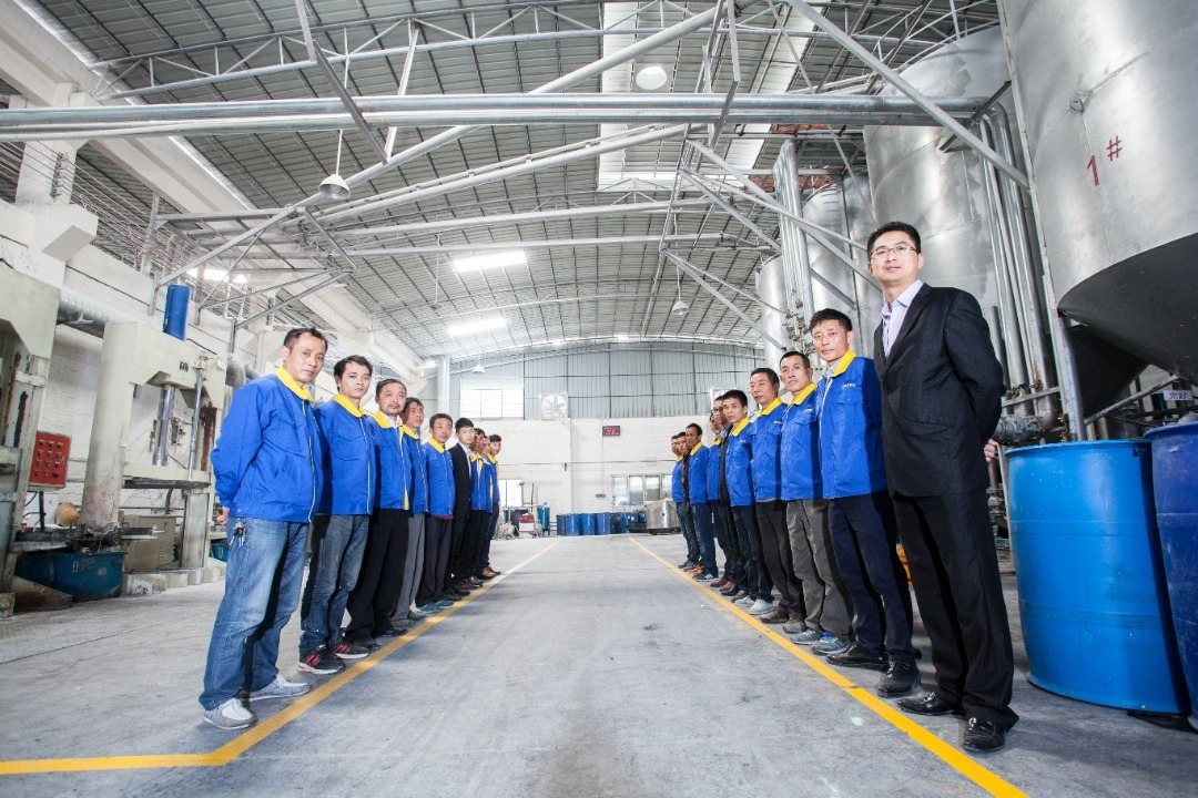 Factory team standing inside a sealant manufacturing area