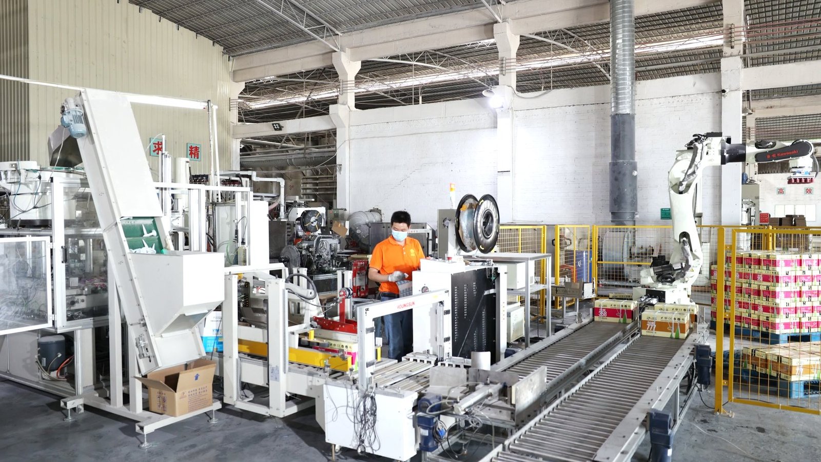 Automated packaging line with conveyor and operator in the Vesta manufacturing area