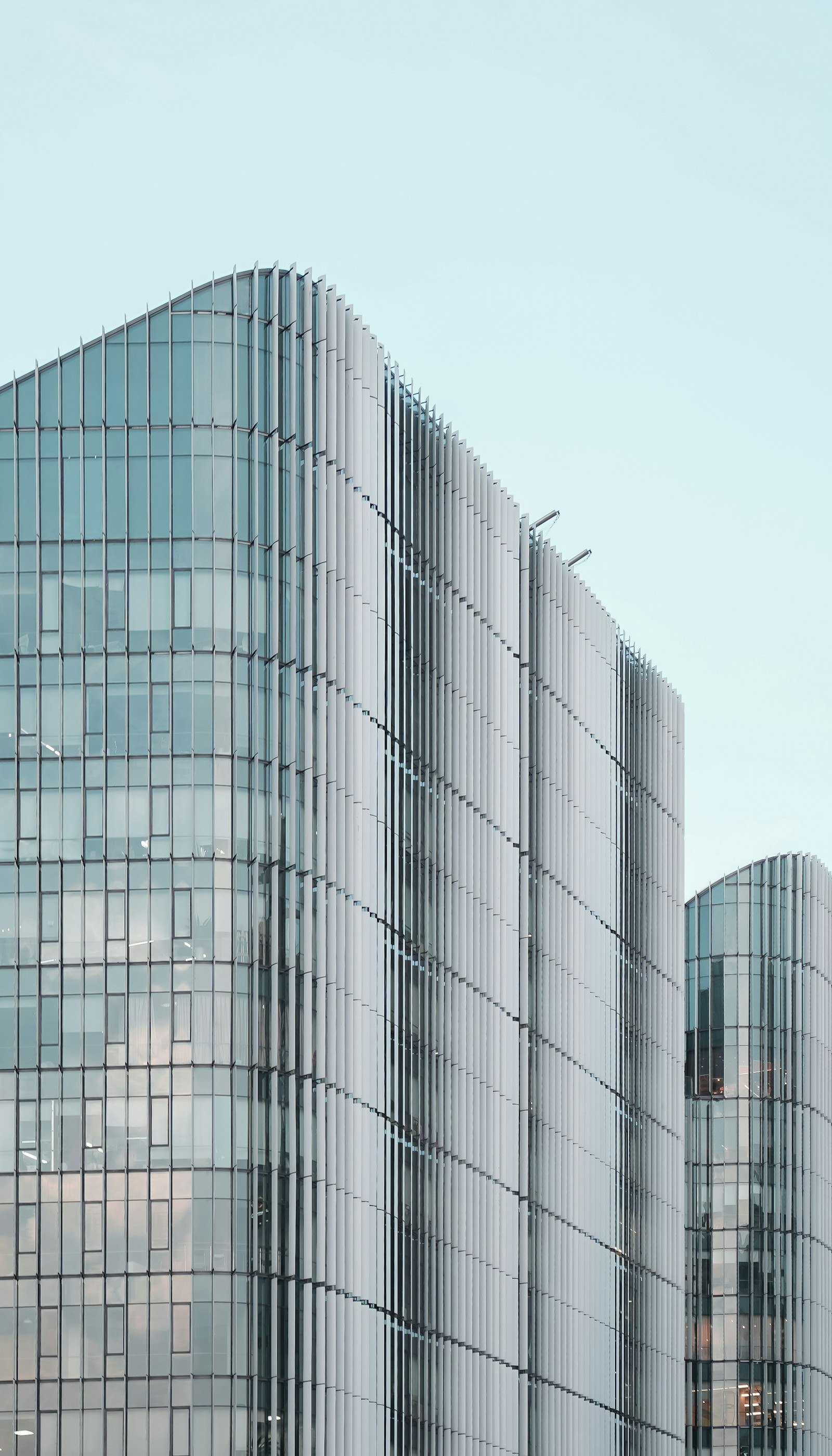 Glass curtain-wall building with white vertical fins