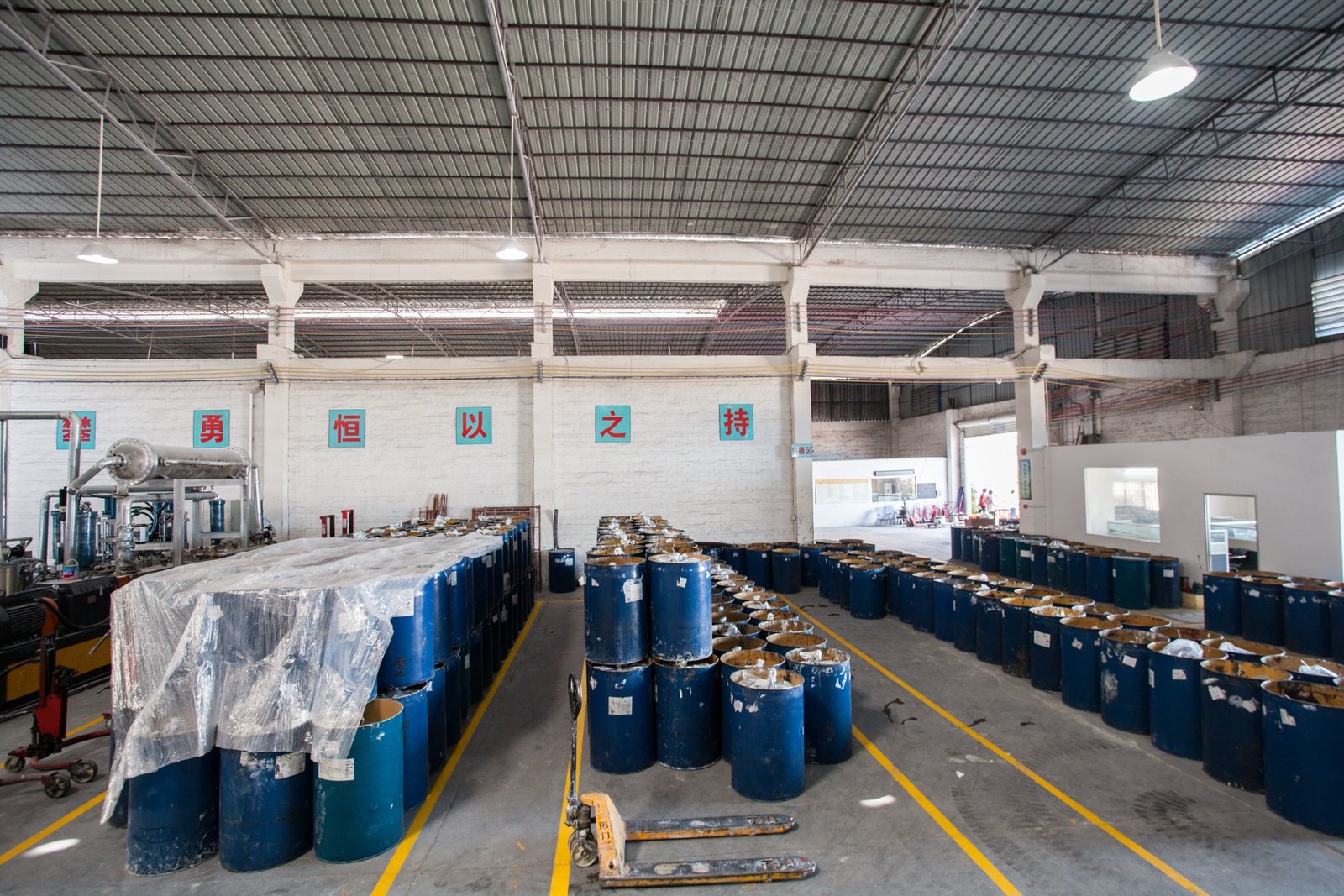 Materials staged in drums inside the Guangzhou sealant production facility