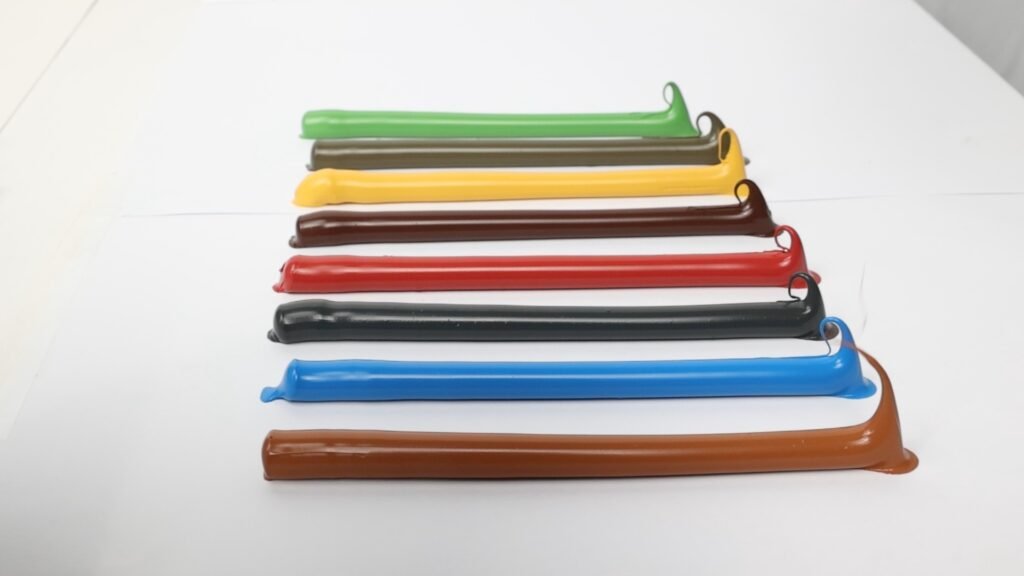 Extruded sealant samples in multiple colors arranged on a white surface for visual comparison.