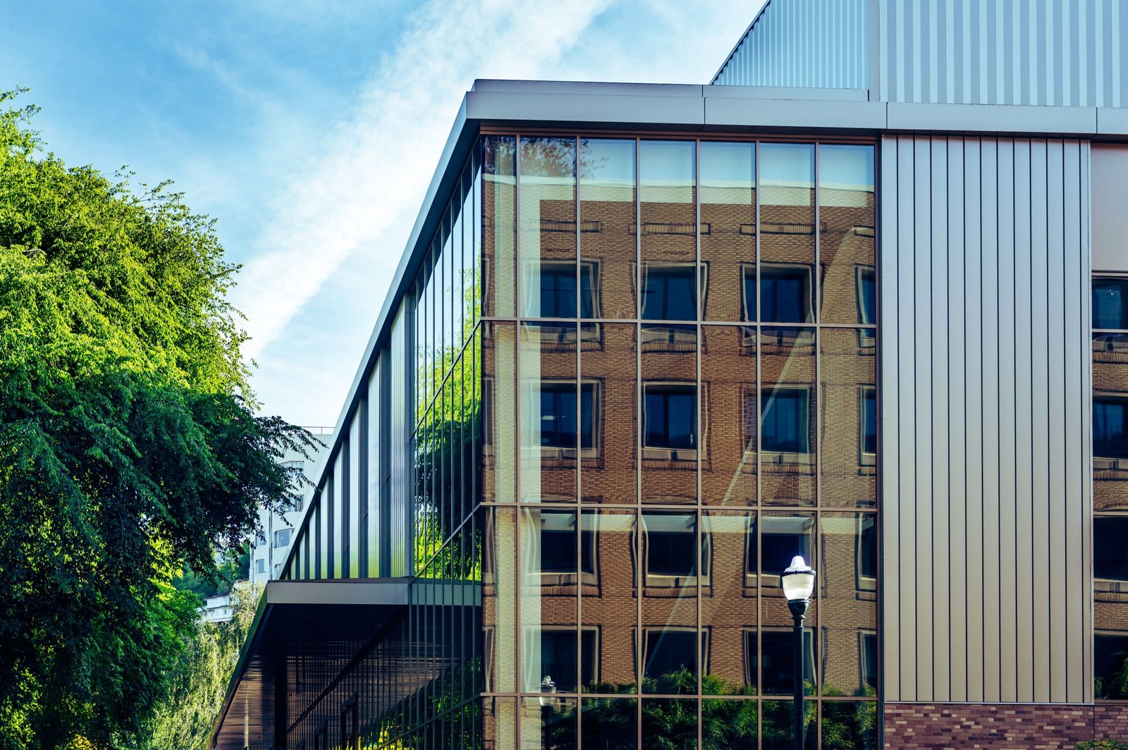 Reflective glass facade with metal framing and visible vertical and horizontal panel joints.
