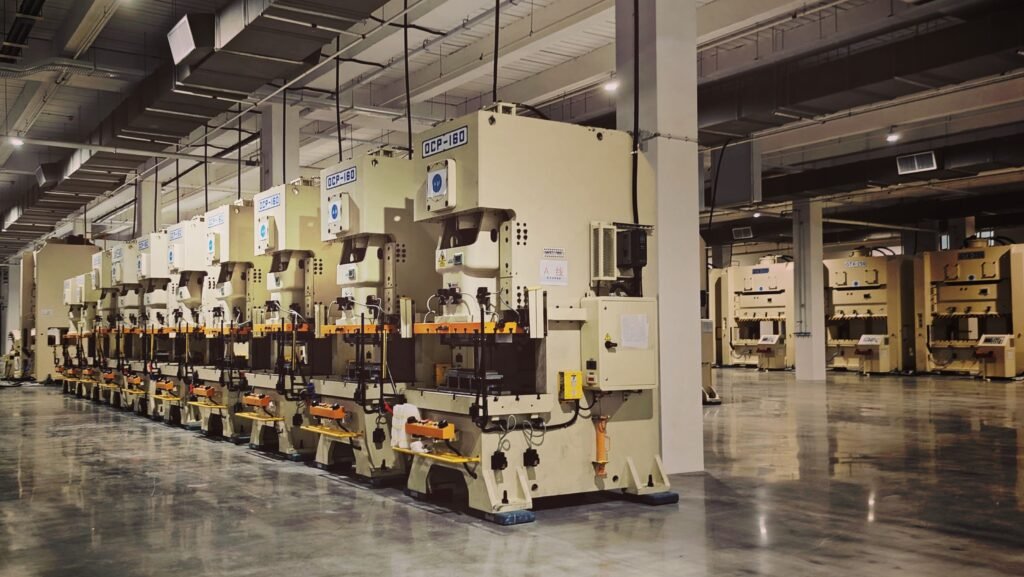 Rows of industrial machines on a clean factory floor.